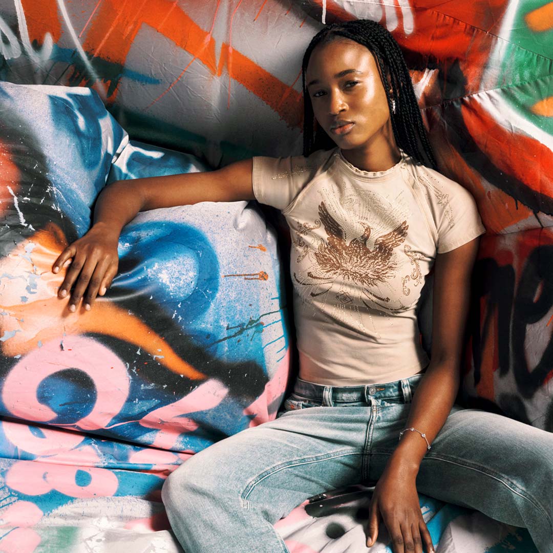 Shop women's t-shirts featuring a model showcasing a graphic t-shirt from the Fall Winter 2025 Collection