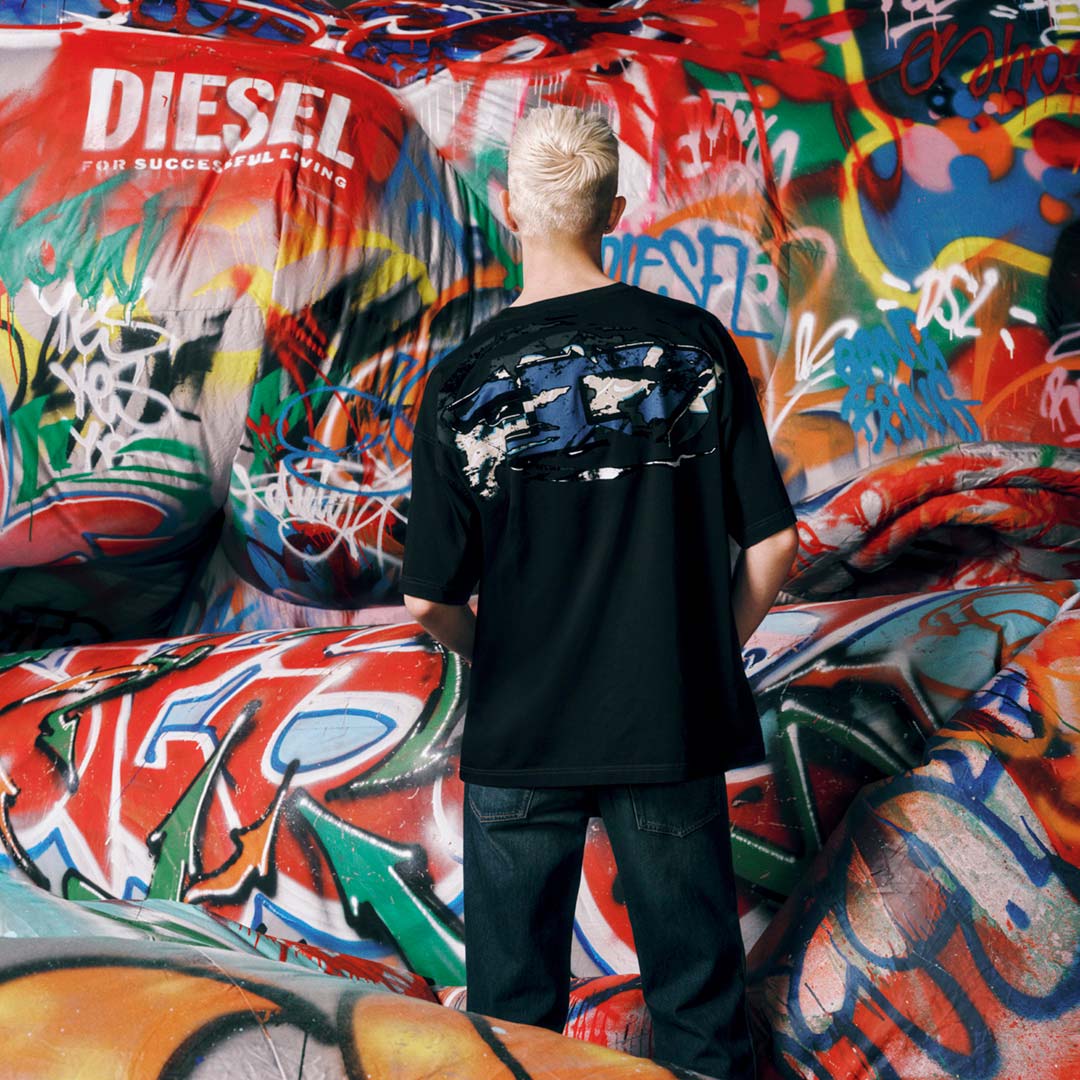 Shop men's t-shirts featuring a model showcasing a graphic t-shirt from the Fall Winter 2025 Collection